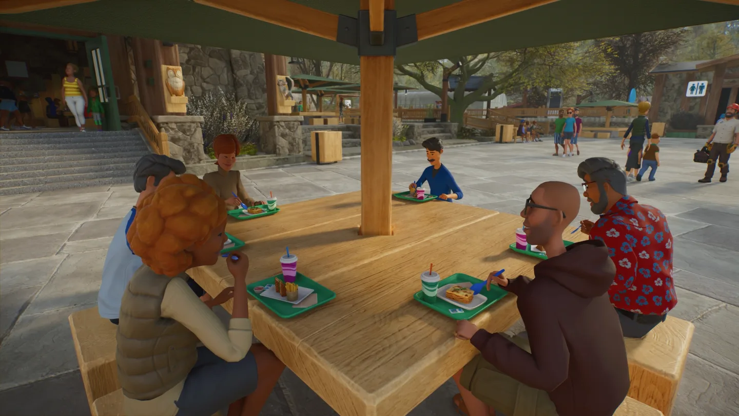 Visitors seated with food in a covered zoo restaurant