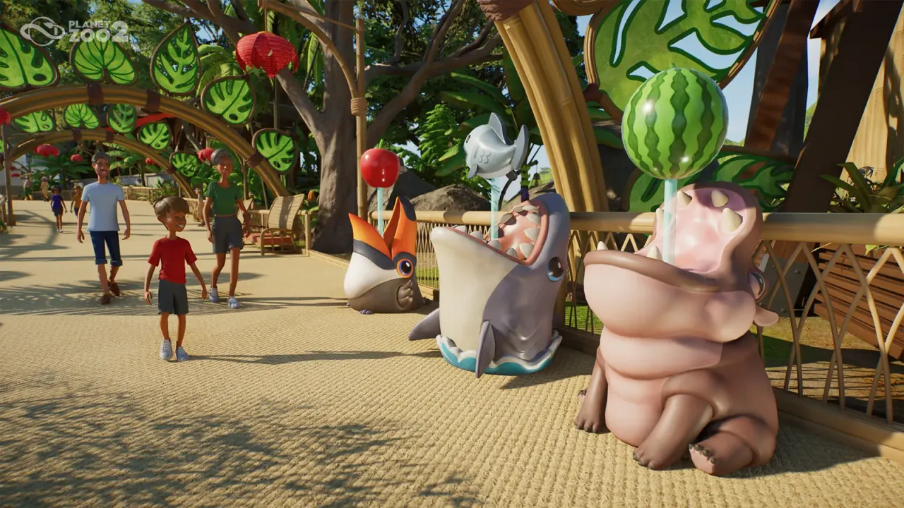 Toucan, shark and hippo themed donation bins beside a zoo path